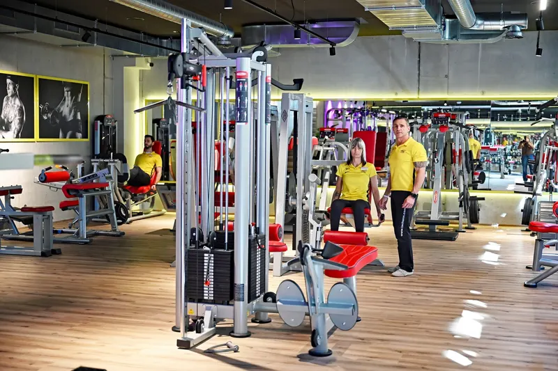 Trainingsfläche des Gesundheitszentrums Tschann in Feldkirch mit Trainern in gelben Shirts