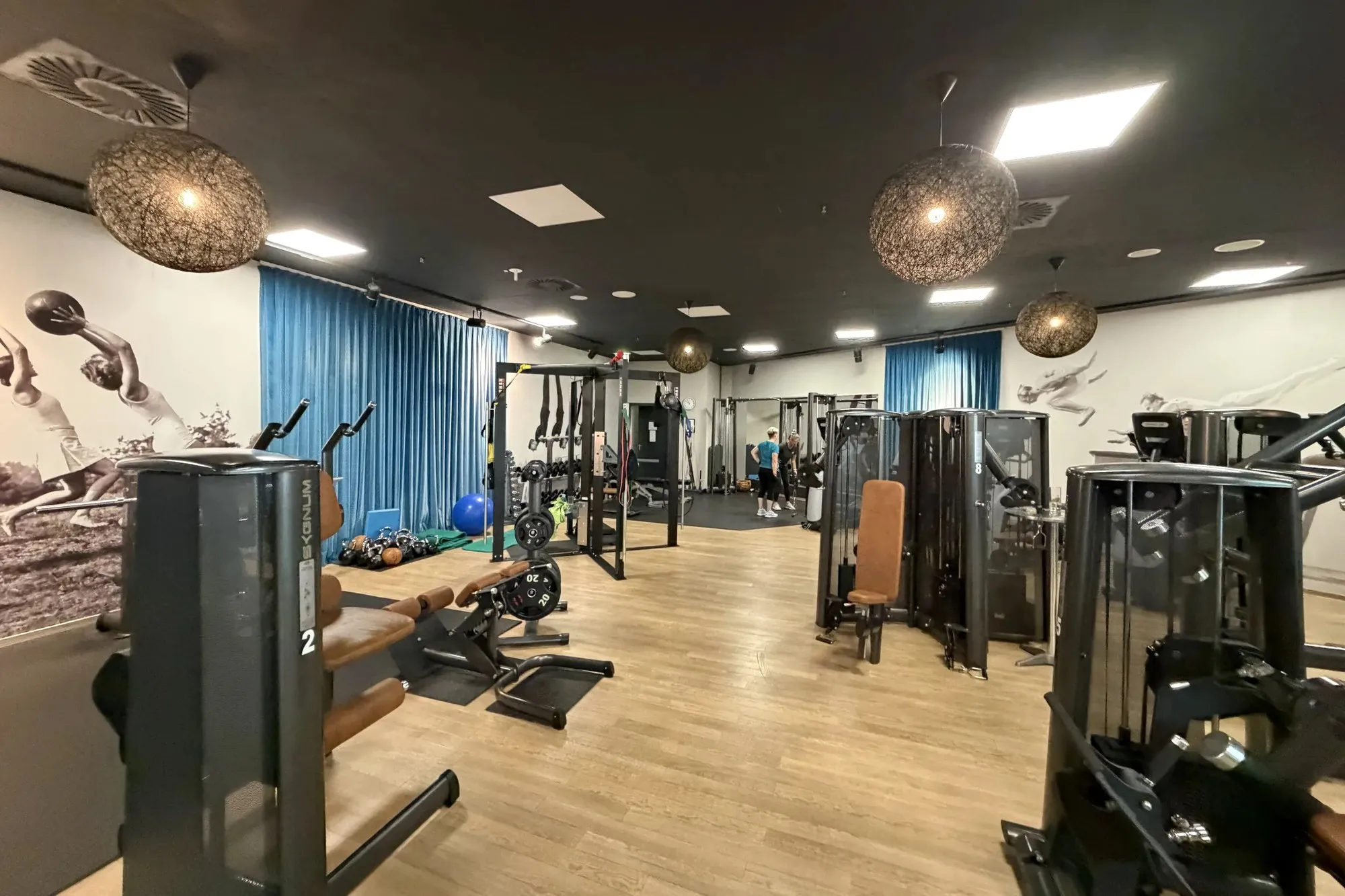 Trainingsfläche von New Circles in Schwerin mit Kraftgeräten und blauen Vorhängen